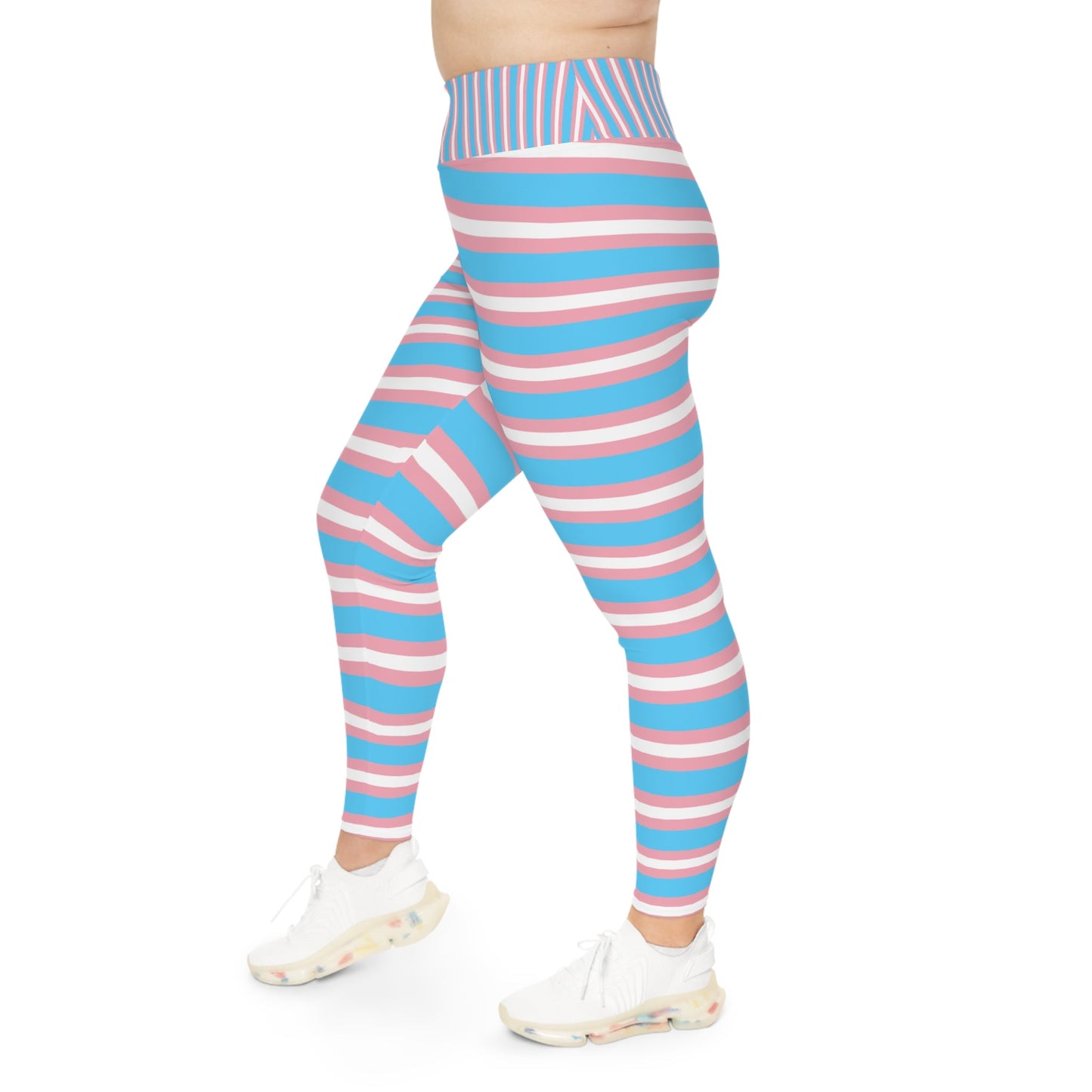 A person is modeling vibrant Trans Pride Plus Size Leggings (available in sizes 2XL - 6XL), featuring horizontal stripes in blue, pink, and white to represent transgender pride. The leggings are coordinated with white sneakers against a plain white background. The image focuses solely on the lower body, excluding the upper body and face.