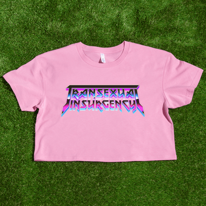 Pink crop top with 'Transsexual Insurgence' text on a grass background