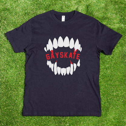 The Vampire Skate - Local hand printed t-shirt is a black AS Colour tee on grass, showing a large white teeth graphic and bold red "GAYSKATE." This Halloween shirt is made by a queer-owned small business.