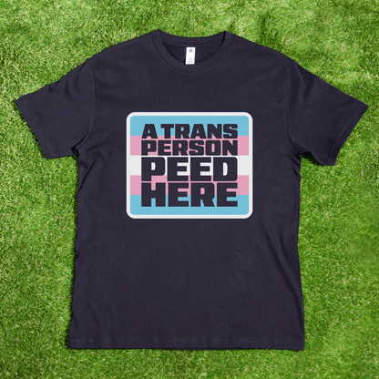Black t-shirt with 'A Trans Person Peed Here' text 