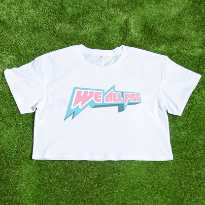 White crop t-shirt with 'We All Piss' trans rights graphic on grass